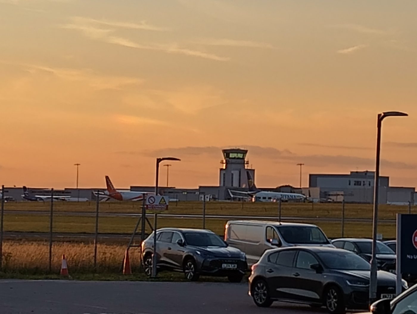 Bristol Airport terminal and control tower at sunset